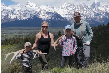 Trustee Carissa Paulson with her family with mountains in the background.